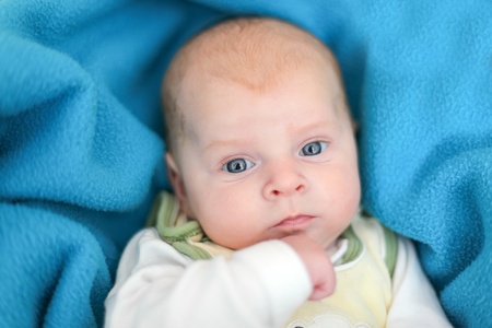 Adorable newborn baby boy with blue eyesの写真素材