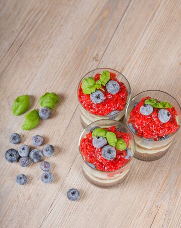 Sweet dessert tiramisu with strawberry, fresh blueberry and basil creamの写真素材