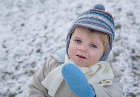 Adorable toddler boy on beautiful winter snowy dayの写真素材