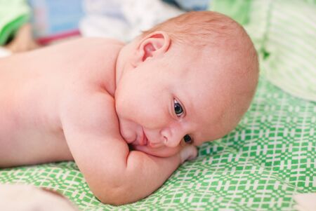 Adorable baby boy with blue eyes three months old after taking bathの写真素材