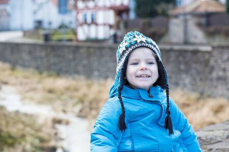 Portrait of little boy of two years in blue clothes outdoorの写真素材