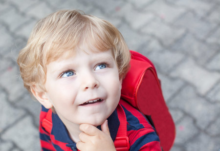 Little toddler boy on way to kindergarten outdoor