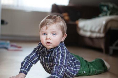 Adorable baby boy learning crawling indoorの写真素材