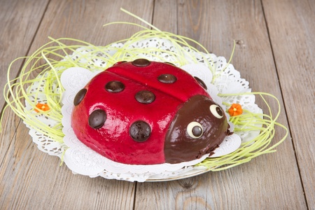 Ladybird cake on wooden background for Easter or birthdayの写真素材