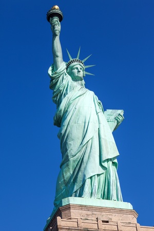 The Statue of Liberty free of tourists and New York City Downtown on sunny early morningの写真素材