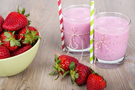 Strawberry healthy smoothie drink. On wooden background.の写真素材