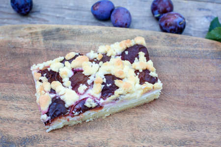 Fresh baked plum cake on wooden backgroundの写真素材