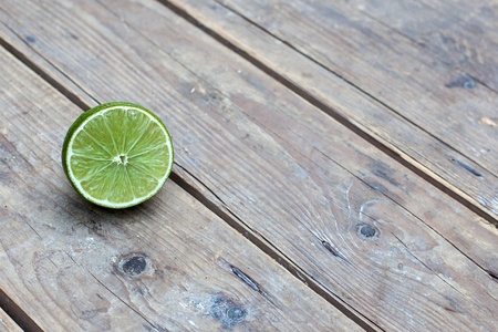 Fresh ripe lime on old wooden backgroundの写真素材