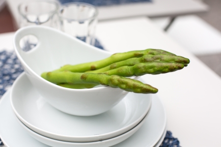 Green asparagus in bowl, summer garden decorationの写真素材