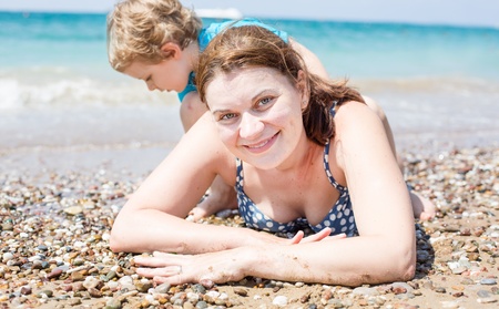 Young mother and little son having fun on beach vacationの写真素材