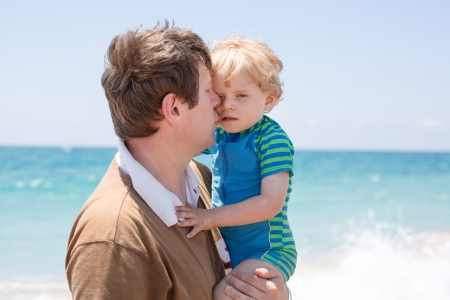 Portrait of mother and her little son on a beachの写真素材