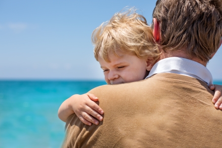 Portrait of mother and her little son on a beachの写真素材