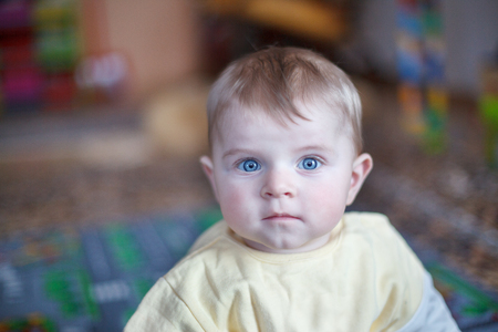 Portrait of cute baby boy of 6 months at homeの写真素材
