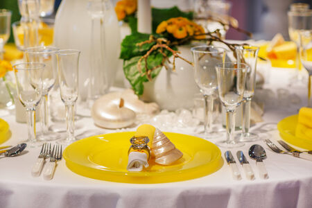 Elegant table set in soft creme and yellow for wedding or event partyの写真素材