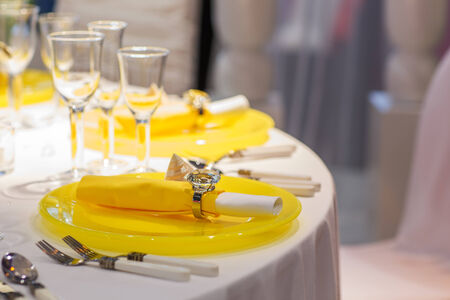 Elegant table set in soft creme and yellow for wedding or event partyの写真素材