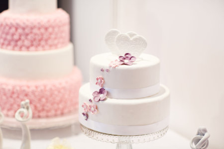 Delicious beautiful wedding cake in white , creme and pink.