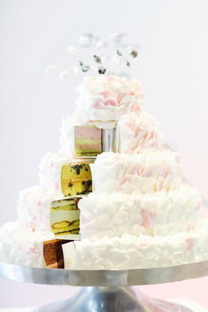 Delicious beautiful wedding cake in white , creme and pink.の写真素材