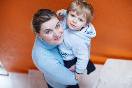 Portrait of young mother with her cute toddler son smilingの写真素材