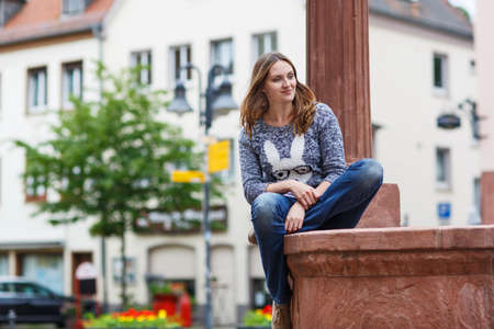 Beautiful woman posing at the camera in german city, outdoorsの写真素材