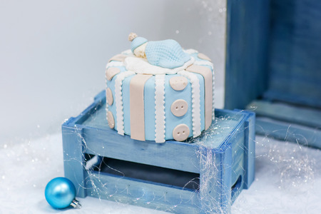Baby birthday cake in soft blue and white, as gift for birth or christening party.の写真素材