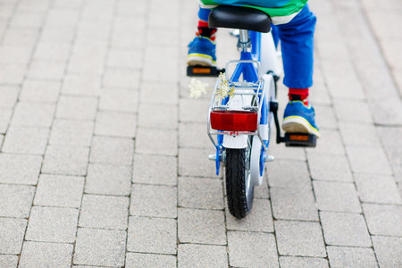 Little child on first bicycle. Active leisure for kids. Child on the way to school.