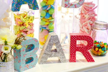 Sweet table as candy bar with different sweets on dinner or event partyの写真素材