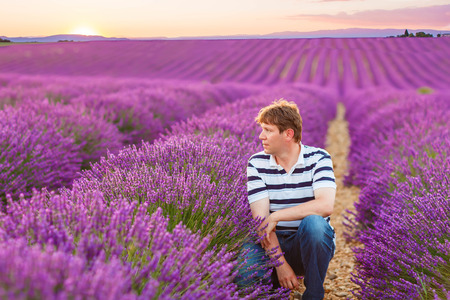 Romantic man in lavender fields, having vacations in Provence, France. Tourist traveling through Valensole plateau.の写真素材