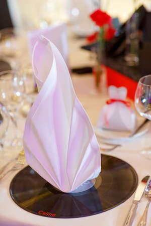 Beautiful elegant table set  for wedding or event party in red, black and white with flowers, indoorsの写真素材