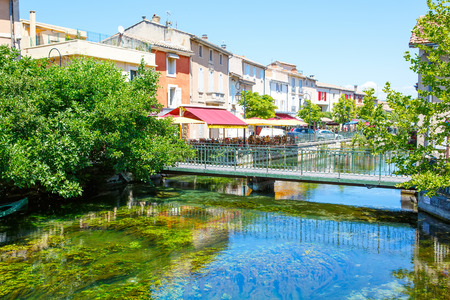 L'Isle-Sur-La-Sorgue, a small typical town in Provence, France. Beautiful village, with view on roof and landscape, small cafe and restaurants.の写真素材