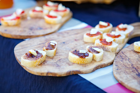 Different tapenade of black and green olives with garlic bread on provencal street market in...