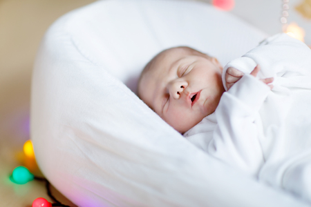 Portrait of cute adorable newborn baby girl sleepingの写真素材