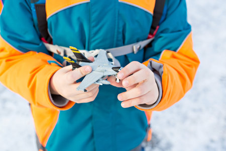Little child holding toy airplane in handsの写真素材