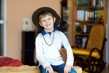 Portrait of little school kid boy wearing cowboy hatの写真素材