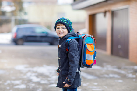 Little school kid boy of elementary class walking to school.の写真素材