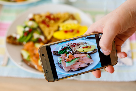 Smartphone taking picture from organic healthy sandwiches.の写真素材