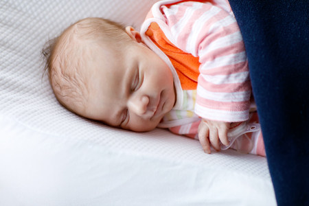 Portrait of cute adorable newborn baby girl sleepingの写真素材