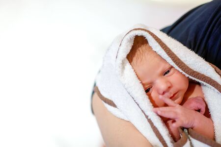Mother holding her newborn baby daughter after birth on arms.の写真素材