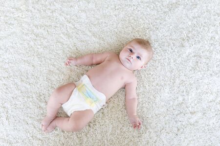 newborn baby girl with diapers. Dry skin and nurseryの写真素材