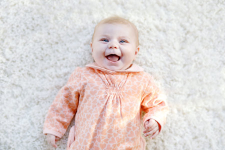 Cute baby girl playing with colorful rattle toy