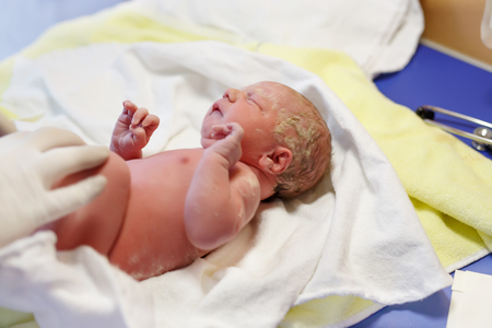 Newborn child seconds and minutes after birth. Check upの写真素材