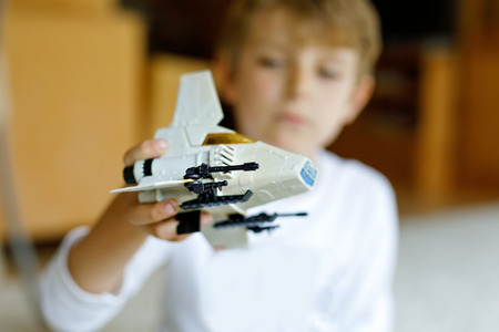 Happy little kid boy playing with space shuttle toy.の写真素材
