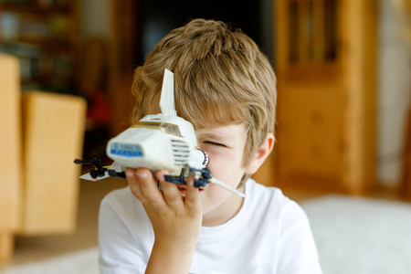 Happy little kid boy playing with space shuttle toy.の写真素材