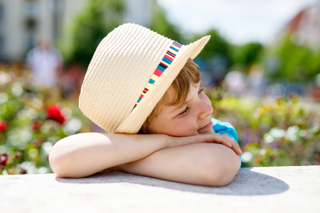 Portrait of little kid boy in hat in summer. Happy child.の写真素材