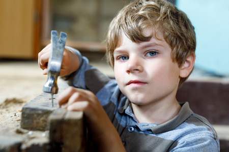 Little kid boy helping with toy tools on construciton site.の写真素材
