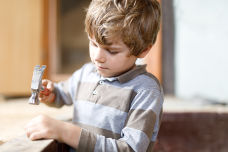 Little kid boy helping with toy tools on construciton site.の写真素材