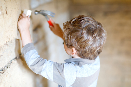 Little kid boy helping with toy tools on construciton site.の写真素材