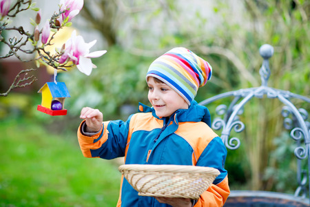 Cute adorable little kid boy making an egg hunt on Easter.の写真素材