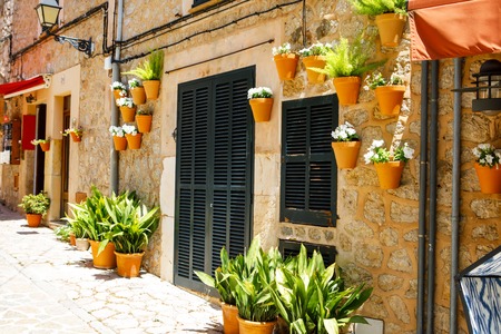 Beautiful street in Valldemossa with traditional flower decoration, famous old mediterranean village of Majorca. Balearic island Mallorca, Spainの写真素材