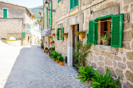 Beautiful street in Valldemossa with traditional flower decoration, famous old mediterranean village of Majorca. Balearic island Mallorca, Spainの写真素材