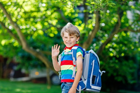 little kid boy with school satchel on first day to schoolの写真素材